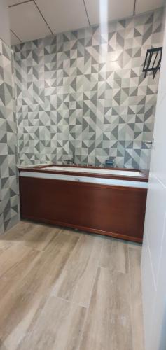 a room with a room with a wall with tiles at Apartamentos Las trece llaves Jacuzzi bajo reserva in Merida
