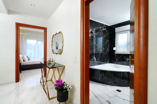 a bathroom with a sink and a bath tub at Villa Valia Calda in Limenas