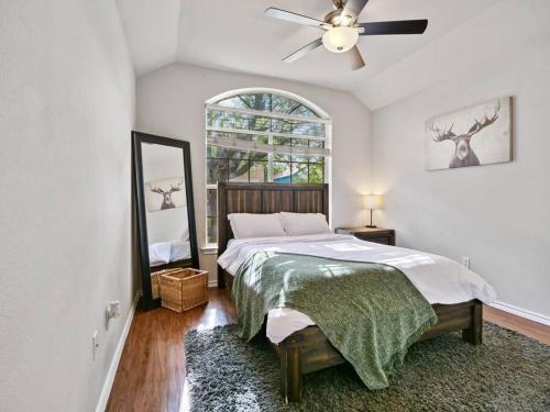 a bedroom with a bed and a ceiling fan at Cozy Getaway, Minutes from Austin! in Round Rock