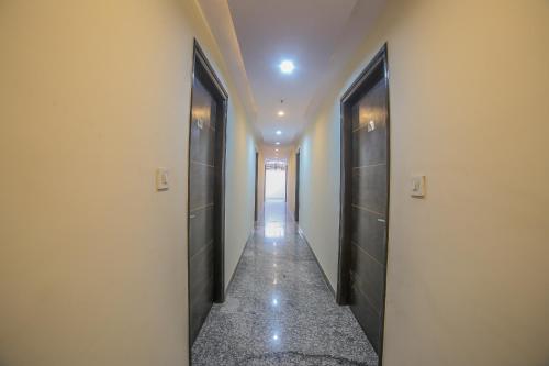 a hallway with black doors and a hallway with a corridorngthngthngthngthngth at Hotel Morgan in Jaipur