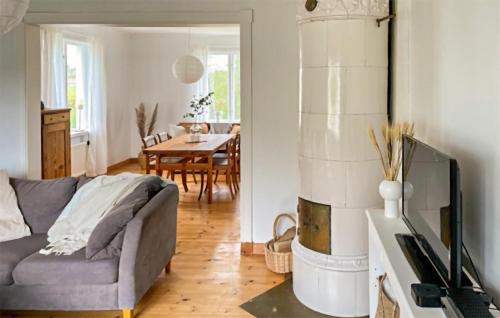 a living room with a couch and a table at Gorgeous Home In Lyrestad With Wifi in Lyrestad