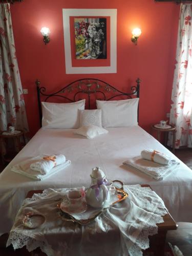 a red bedroom with a bed with a tea set on it at Dimitra House in Mithymna