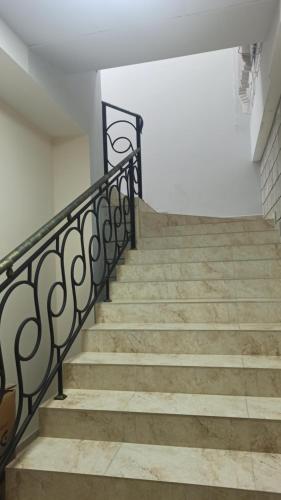 a set of stairs with a black railing at Hotel SESIL in Gyumri