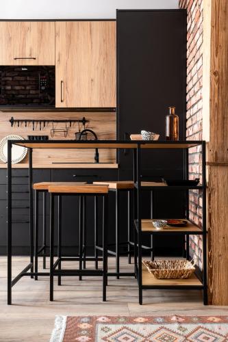 a kitchen with a black counter and wooden cabinets at Apartament Czarna Perła in Czarny Dunajec
