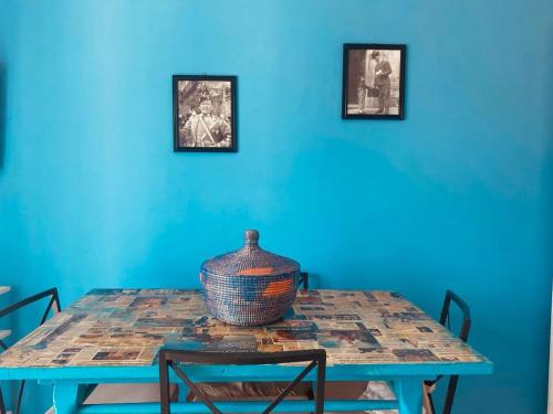 una habitación azul con una mesa con un jarrón encima en CasaAzul, en Sperlonga