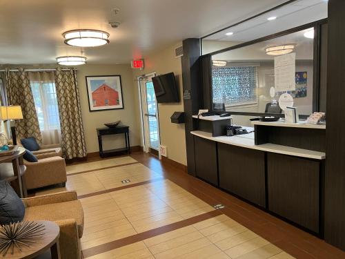 a lobby with a counter and a waiting room at Candlewood Suites Washington-Dulles Herndon by IHG in Herndon