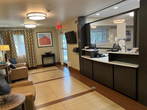 a living room filled with furniture and a kitchen at Candlewood Suites Washington-Dulles Herndon, an IHG Hotel in Herndon