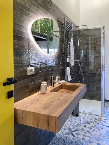 a bathroom with a wooden sink and a mirror at Don Ciccio Capashome in Ceglie Messapica