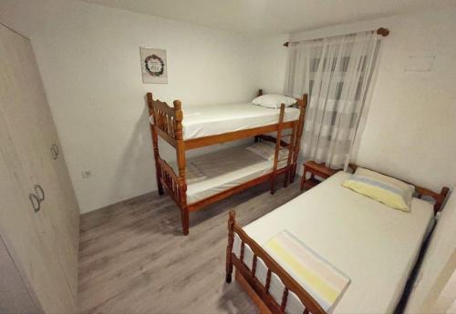 a small room with two bunk beds in it at 1-bedroom apartment with 3 beds + private parking in Tivat