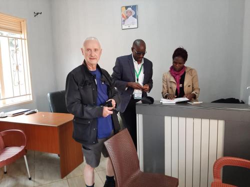a man standing next to a counter in a room at Jusvero Motel in Jinja