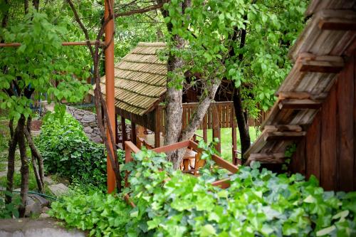 a garden with a wooden building and some trees at Dil Hill by Sam in Dilijan