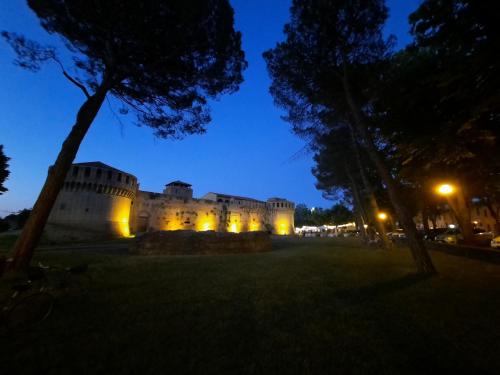 a castle lit up at night with lights at Cà Rossa in Imola