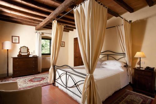 a bedroom with a bed with a canopy at Monsignor Della Casa Country Resort & Spa in Borgo San Lorenzo