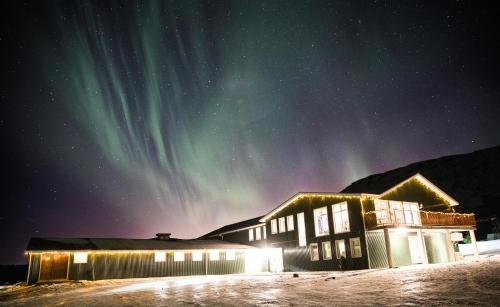 a large building with a sky background at Farmhotel Efstidalur in Laugarvatn