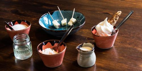 a group of cups with ice cream and a bowl of food at Farmhotel Efstidalur in Laugarvatn