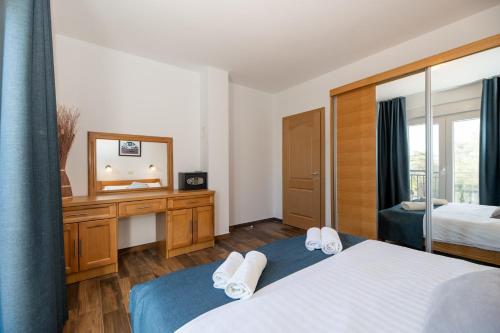 a hotel room with a bed and a mirror at Lucija in Starigrad-Paklenica