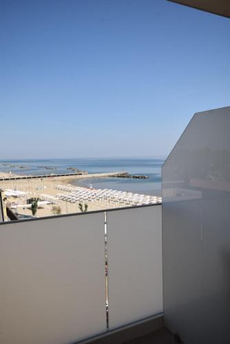 a view of the beach from the balcony of a building at Hotel Mondial in Bellaria-Igea Marina