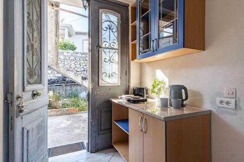 a kitchen with a door and a counter and a door at Villa Maria Mountain View in Himare