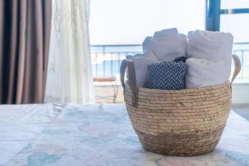 a basket filled with towels sitting on a table at Villa Maria Mountain View in Himare