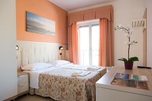 a hotel room with a bed and a window at Hotel Saint Tropez - Pineto in Pineto