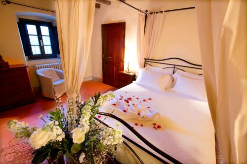 a bedroom with a bed with flowers on it at Monsignor Della Casa Country Resort & Spa in Borgo San Lorenzo