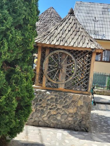 a building with a clock on the side of it at Pension Bud in Onceşti