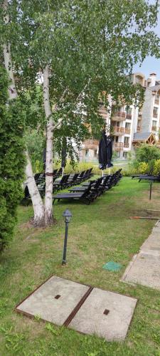 a parking meter in the grass next to a park at St Ivan Rilski Spa Luxury apartment Bansko & Free SPA in Bansko