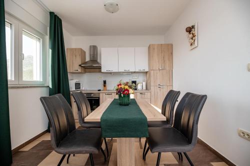 a kitchen with a dining room table and chairs at Lucija in Starigrad-Paklenica