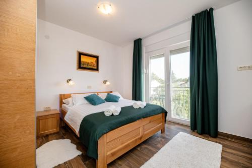 a bedroom with a bed and a window at Lucija in Starigrad-Paklenica