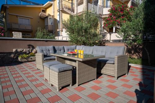 a patio with a table and chairs on a patio at Lucija in Starigrad-Paklenica