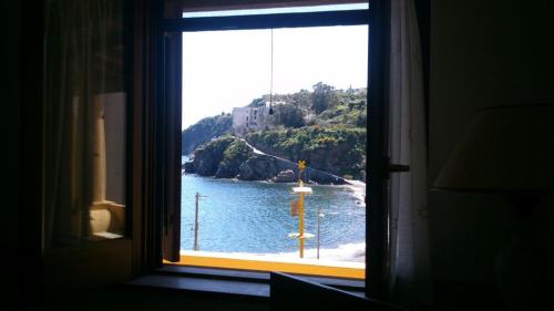 a window with a view of a body of water at Casa vacanze Lipari da Sergio spiaggia sotto casa in Lipari