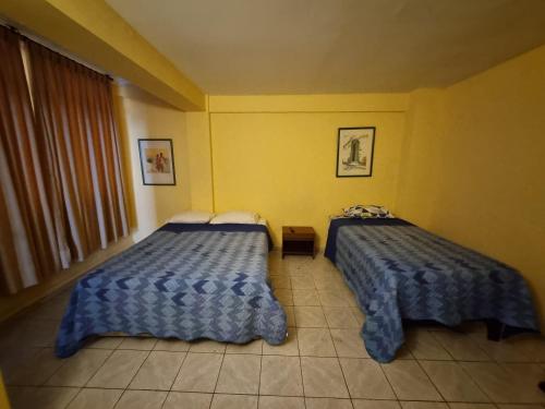 Łóżko lub łóżka w pokoju w obiekcie HOTEL ASTORE Matta 2537