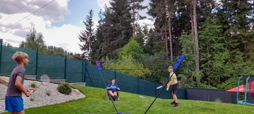 a group of children playing a game of tennis at Apartmány Aktiv Lipno in Lipno nad Vltavou