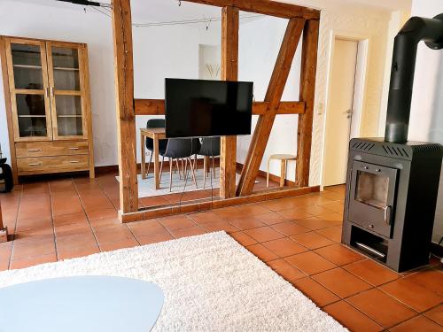 a living room with a wood stove and a television at Ferienwohnung Till in Mölln