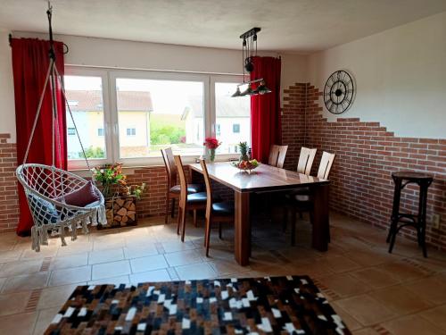 a dining room with a wooden table and chairs at Casa del Norte in Brackenheim