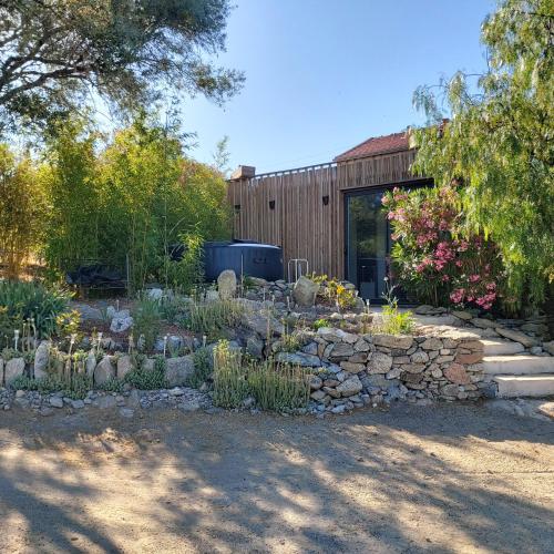 a garden with a stone wall and a building at In casa in Casta