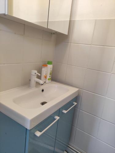 a bathroom with a white sink and a mirror at Les lumières du phare in Calais