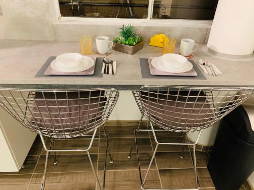 a table with two chairs and plates on it at El Rincon Amarillo. Zona Dorada. in Tijuana