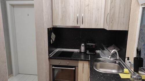 a kitchen with a sink and a counter top at Burgas Central-Sheynovo in Burgas City