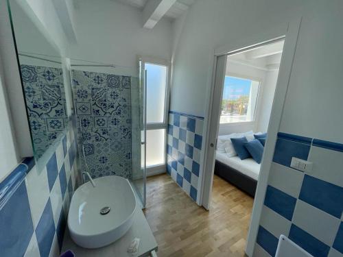 a bathroom with a toilet and a sink in a room at ITINERA Baia Verde Rooms and Breakfast in Gallipoli