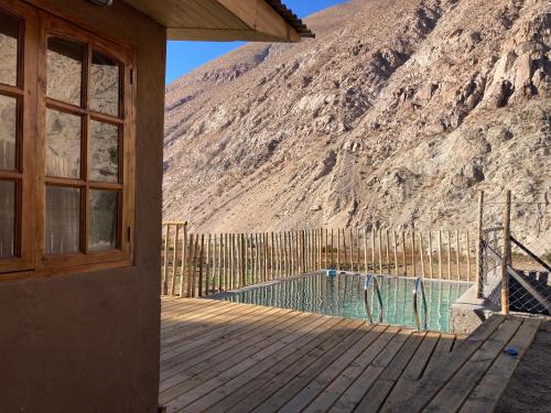 a house with a swimming pool next to a mountain at Casa Almendro in Monte Grande