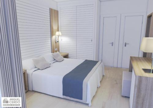 a bedroom with a large white bed with two pillows at Hotel Morlans in Paguera