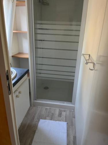 une douche dans une salle de bain avec une porte vitrée dans l'établissement Mobil home bungalow 6 personnes villeneuve loubet plage marina baie des anges, à Villeneuve-Loubet