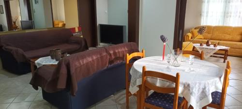 a living room with a table and a couch at KALLIOPI'S HOUSE in Zilotí