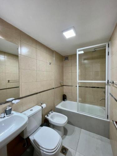 a bathroom with a toilet and a sink and a shower at Altos de Argentina in San Miguel de Tucumán