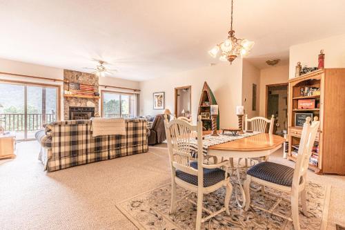 a dining room and living room with a table and chairs at Condo with Stunning Mountain and 6th Green views near Harrahs Cherokee Bryson City in Whittier