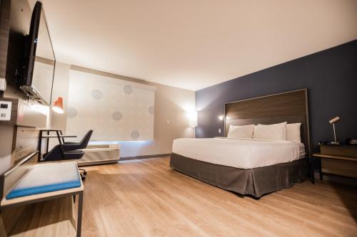 a hotel room with a bed and a television at Tru By Hilton Yarmouth, Ns in Yarmouth