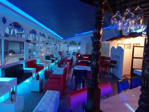 a restaurant with tables and chairs and lights at Hotel Boutique TEKALI INN in Cuetzalán del Progreso