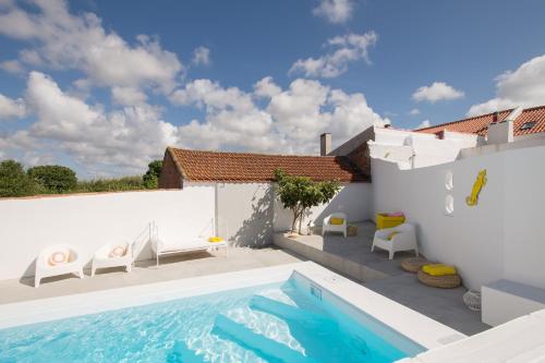 a villa with a swimming pool and a house at CASASUPERTUBOS® Villa 9 & Apart 1-8 in Atouguia da Baleia
