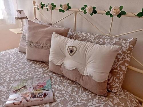 a bed with a bunch of pillows on it at Casa nella Natura Il Risveglio degli Elfi in Pedavena